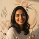 Portrait of a smiling South Asian woman, representing a happy and trusted customer.